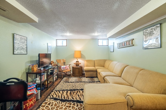 1209 Edgemont St, Des Moines, IA 50315 - living area featuring a textured ceiling, wood finished floors, plenty of natural light, and a textured wall