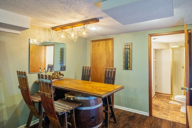 1209 Edgemont St, Des Moines, IA 50315 - dining area featuring a textured ceiling, dark wood-style floors, and a textured wall