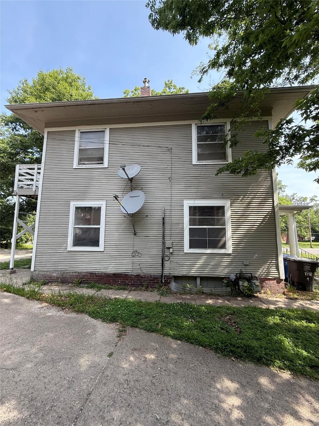 1148 36th St, Des Moines, IA 50311 - view of property exterior with a chimney