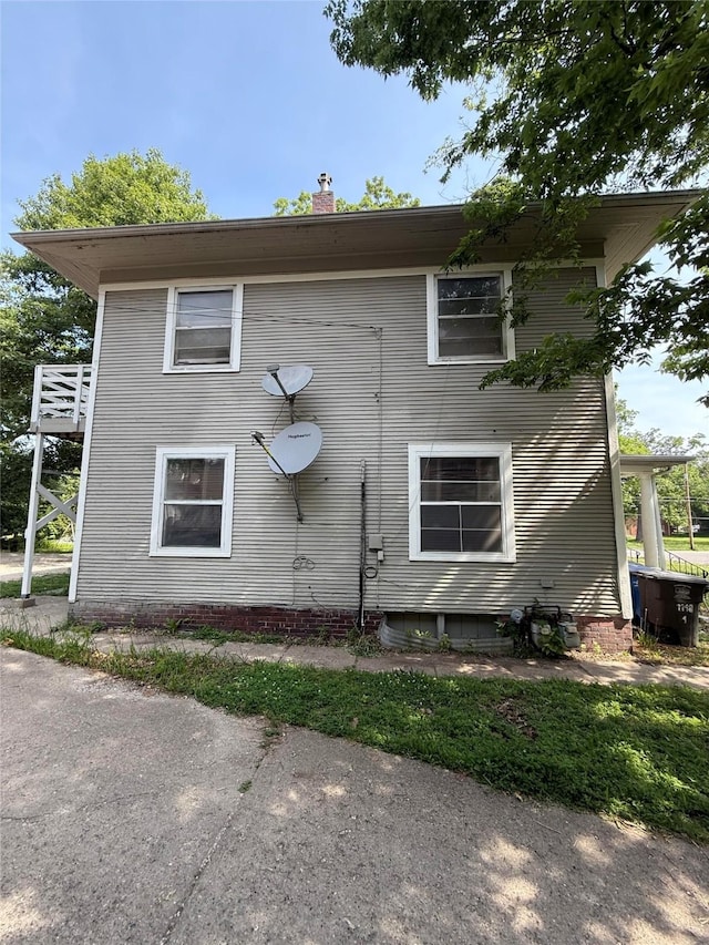 1148 36th St, Des Moines, IA 50311 - view of property exterior with a chimney