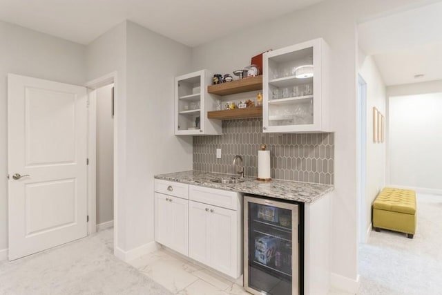5419 166th Ct, Urbandale, IA 50323 - indoor wet bar featuring wine cooler, tasteful backsplash, and light marble finish floors