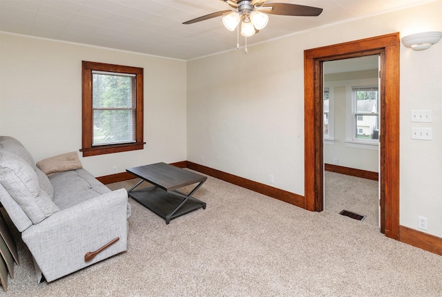 5812 SW 5th St, Des Moines, IA 50315 - living area with carpet, ceiling fan, and ornamental molding