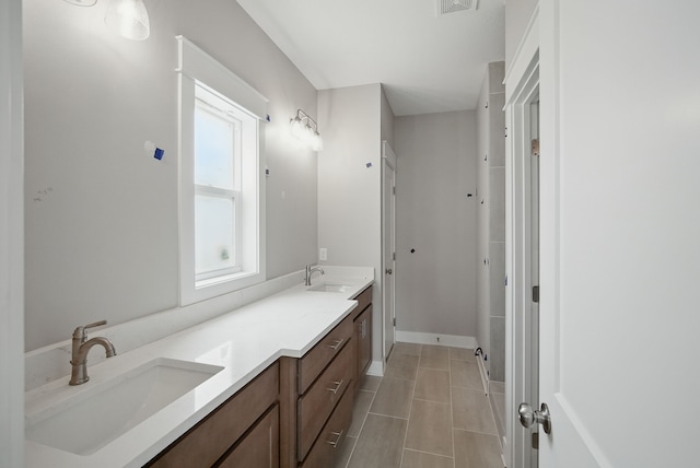 45 NW Alderleaf Dr, Waukee, IA 50263 - full bathroom featuring double vanity and tile patterned flooring