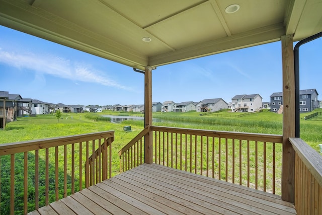 55 NW Alderleaf Dr, Waukee, IA 50263 - wooden terrace featuring a residential view, a yard, and a water view