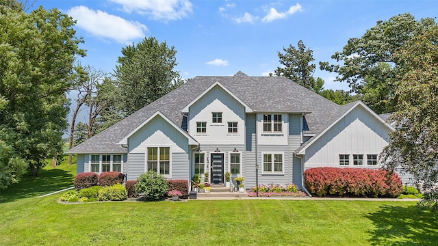 54 Four Winds Dr, Clear Lake, IA 50428 - rear view of property featuring a shingled roof, a yard, and board and batten siding