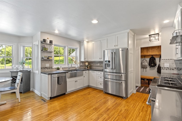 54 Four Winds Dr, Clear Lake, IA 50428 - kitchen featuring stainless steel appliances, white cabinets, light wood finished floors, and recessed lighting