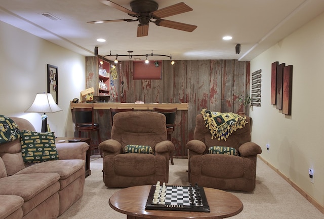 302 Crossing Ct NW, Bondurant, IA 50035 - living area with a bar, carpet flooring, a ceiling fan, wooden walls, and track lighting