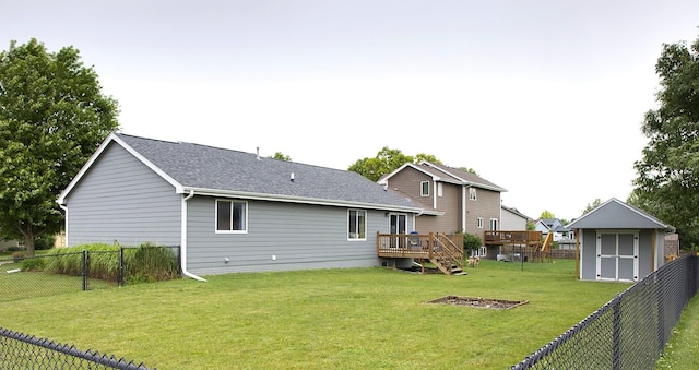 302 Crossing Ct NW, Bondurant, IA 50035 - back of house with a fenced backyard, a shed, a wooden deck, and roof with shingles