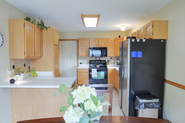 302 Crossing Ct NW, Bondurant, IA 50035 - kitchen featuring black appliances, a peninsula, decorative backsplash, light countertops, and light brown cabinets