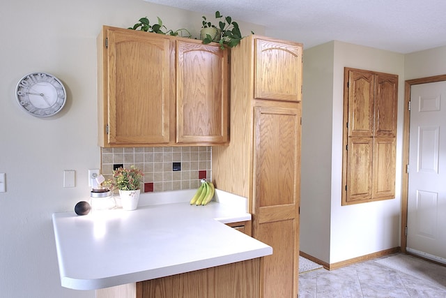 302 Crossing Ct NW, Bondurant, IA 50035 - kitchen featuring light countertops, decorative backsplash, a peninsula, and light tile patterned floors