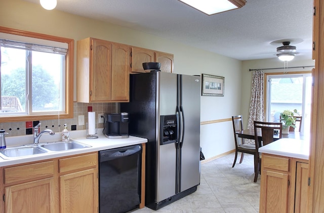 302 Crossing Ct NW, Bondurant, IA 50035 - kitchen featuring dishwasher, stainless steel refrigerator with ice dispenser, plenty of natural light, light countertops, and a textured ceiling