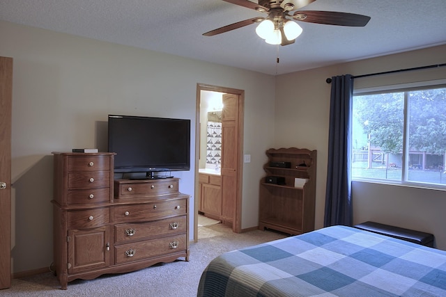 302 Crossing Ct NW, Bondurant, IA 50035 - bedroom with light colored carpet, ensuite bathroom, and a ceiling fan