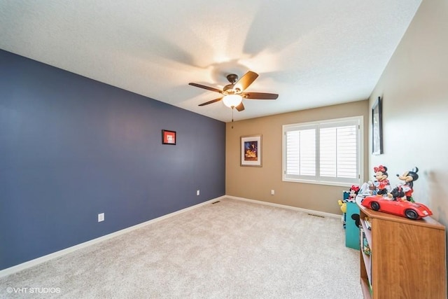 7100 Holcomb Ave, Urbandale, IA 50322 - game room with a ceiling fan and carpet flooring