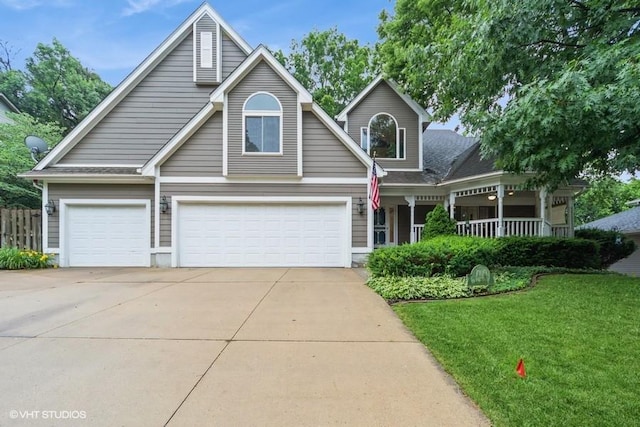 7100 Holcomb Ave, Urbandale, IA 50322 - traditional-style home with driveway, a garage, covered porch, and roof with shingles