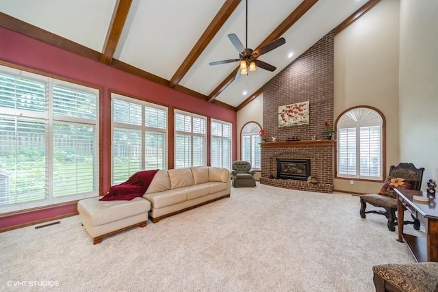 7100 Holcomb Ave, Urbandale, IA 50322 - carpeted living area with high vaulted ceiling, beamed ceiling, ceiling fan, a fireplace, and recessed lighting