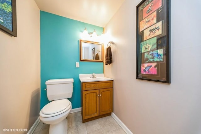 7100 Holcomb Ave, Urbandale, IA 50322 - half bathroom with vanity and tile patterned floors