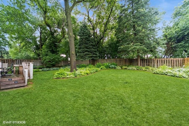 7100 Holcomb Ave, Urbandale, IA 50322 - fenced backyard with a deck