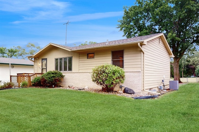 4610 SE 7th St, Des Moines, IA 50315 - view of side of home featuring brick siding, a yard, and roof with shingles