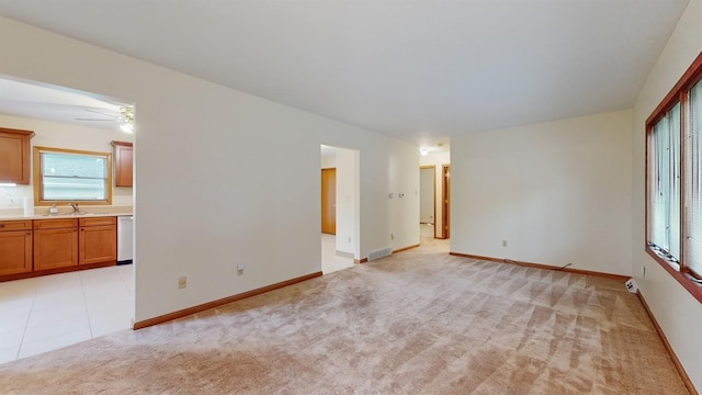 4610 SE 7th St, Des Moines, IA 50315 - unfurnished room featuring light colored carpet and a ceiling fan