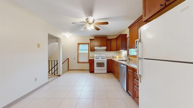 4610 SE 7th St, Des Moines, IA 50315 - kitchen featuring white appliances, under cabinet range hood, ceiling fan, light countertops, and brown cabinets