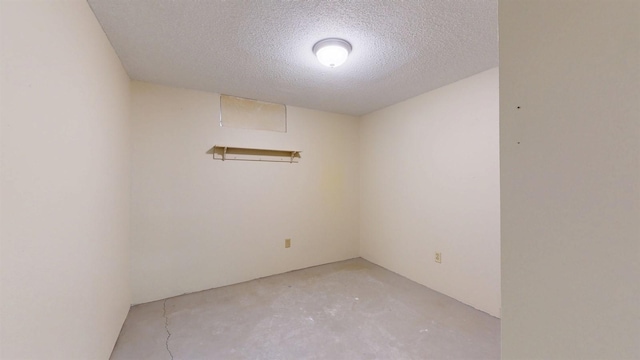 4610 SE 7th St, Des Moines, IA 50315 - spare room featuring concrete flooring and a textured ceiling