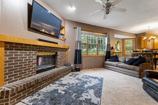 2400 Ridgetop Cir, Ames, IA 50014 - carpeted living room with a textured ceiling, ceiling fan, a fireplace, and a chandelier