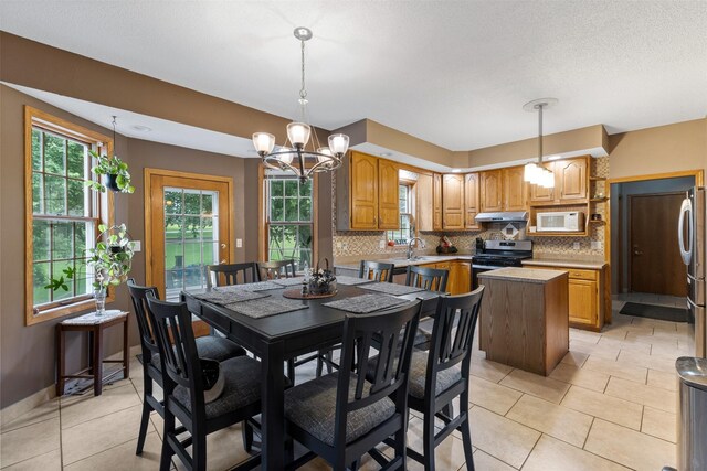 2400 Ridgetop Cir, Ames, IA 50014 - dining room featuring a chandelier, healthy amount of natural light, and light tile patterned floors