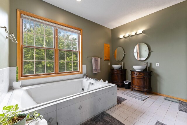 2400 Ridgetop Cir, Ames, IA 50014 - bathroom with double vanity, a tub with jets, and tile patterned flooring