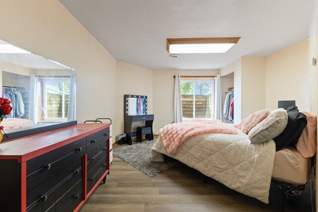 2400 Ridgetop Cir, Ames, IA 50014 - bedroom featuring wood finished floors, a walk in closet, and a closet