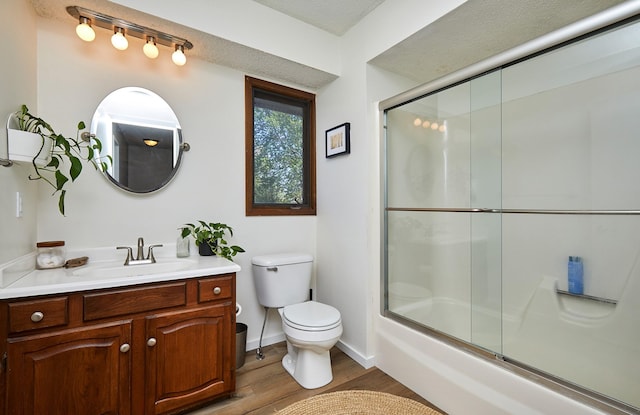 5208 Pommel Pl, West Des Moines, IA 50265 - bathroom with vanity, wood finished floors, and combined bath / shower with glass door