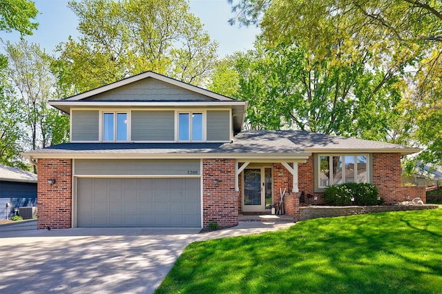 5208 Pommel Pl, West Des Moines, IA 50265 - view of front facade with an attached garage, driveway, a front yard, and brick siding