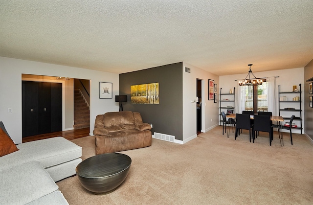 5208 Pommel Pl, West Des Moines, IA 50265 - living area featuring stairway, a chandelier, light colored carpet, and a textured ceiling