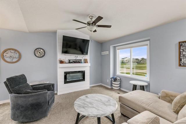 1115 Locust St, Waukee, IA 50263 - carpeted living room featuring vaulted ceiling, a ceiling fan, and a fireplace