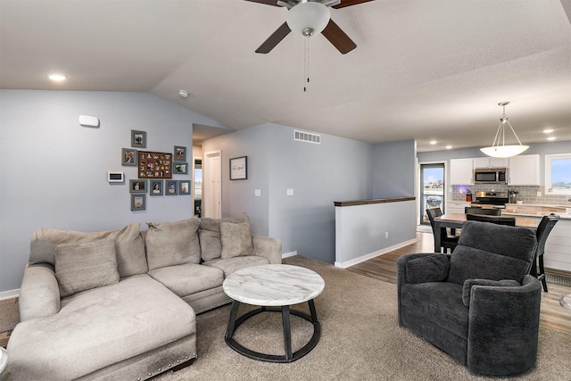 1115 Locust St, Waukee, IA 50263 - carpeted living area with ceiling fan, vaulted ceiling, and recessed lighting