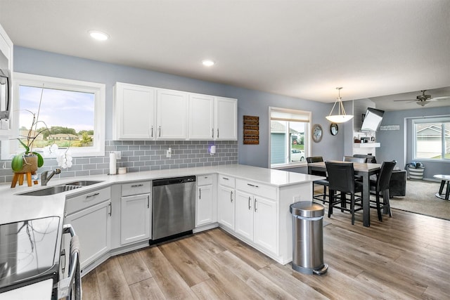 1115 Locust St, Waukee, IA 50263 - kitchen with stainless steel dishwasher, range with electric stovetop, light wood finished floors, light countertops, and recessed lighting