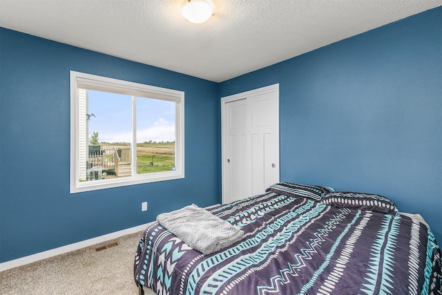 1115 Locust St, Waukee, IA 50263 - carpeted bedroom featuring a closet and baseboards