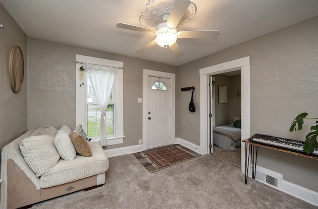 951 28th St, Des Moines, IA 50312 - carpeted foyer with ceiling fan and baseboards