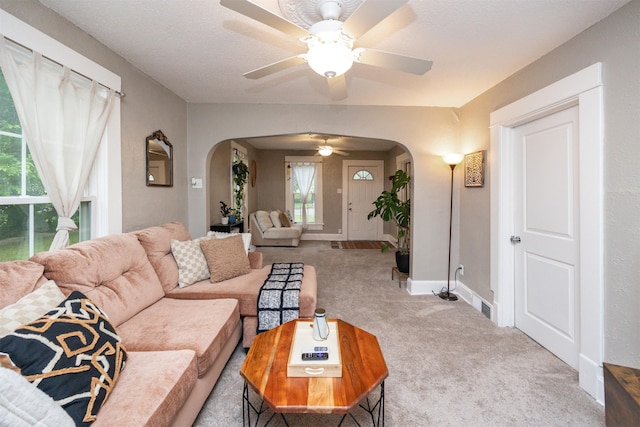 951 28th St, Des Moines, IA 50312 - carpeted living area featuring arched walkways and a ceiling fan