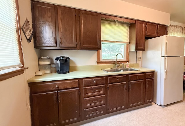 1448 17th St, West Des Moines, IA 50265 - kitchen with freestanding refrigerator, light countertops, light flooring, and dark brown cabinets