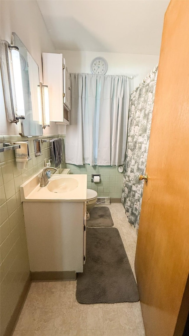 1448 17th St, West Des Moines, IA 50265 - bathroom featuring vanity, tile walls, and tile patterned floors