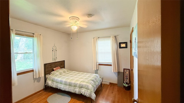 1448 17th St, West Des Moines, IA 50265 - bedroom featuring wood finished floors and a baseboard heating unit