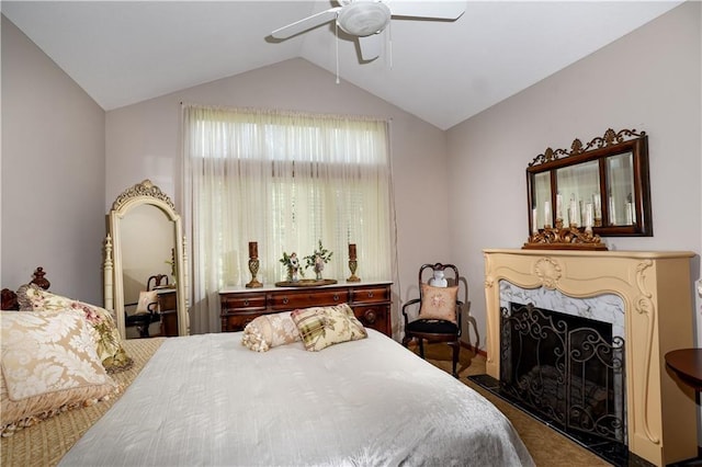 1699 Glade Dr SW, Altoona, IA 50009 - bedroom featuring lofted ceiling, a ceiling fan, carpet floors, and a fireplace