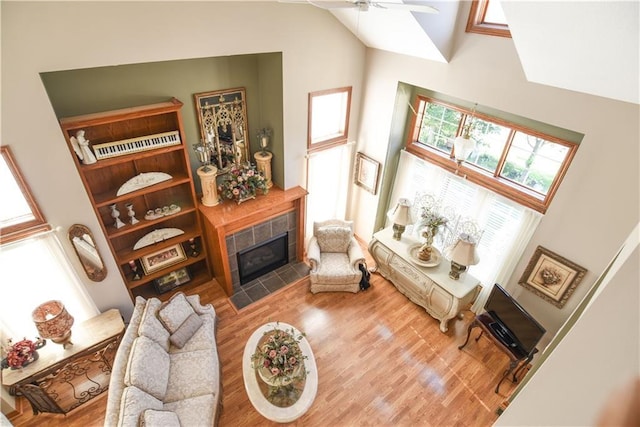 1699 Glade Dr SW, Altoona, IA 50009 - living area featuring high vaulted ceiling, a fireplace, light wood finished floors, and a ceiling fan