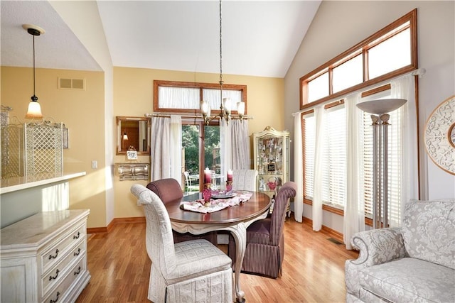 1699 Glade Dr SW, Altoona, IA 50009 - dining area with a chandelier, vaulted ceiling, plenty of natural light, and light wood finished floors