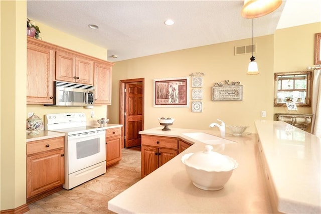 1699 Glade Dr SW, Altoona, IA 50009 - kitchen with stainless steel microwave, white electric stove, light countertops, a peninsula, and pendant lighting