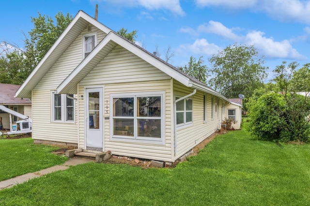 105 N St, Guthrie Center, IA 50115 - back of house featuring a lawn and entry steps