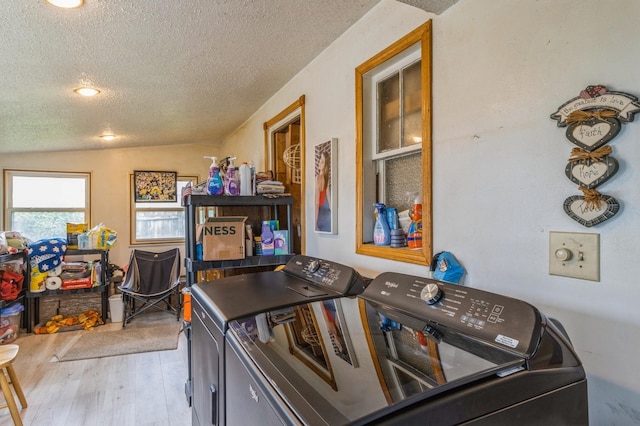 105 N St, Guthrie Center, IA 50115 - laundry room featuring a textured ceiling, washing machine and clothes dryer, and wood finished floors