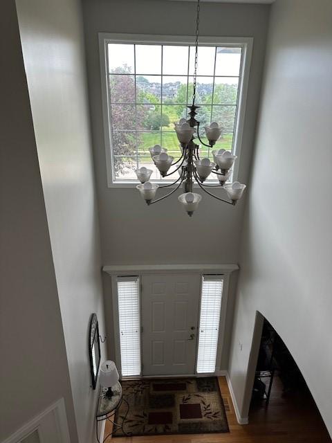 4017 160th St, Urbandale, IA 50323 - foyer entrance featuring a chandelier, wood finished floors, and a high ceiling