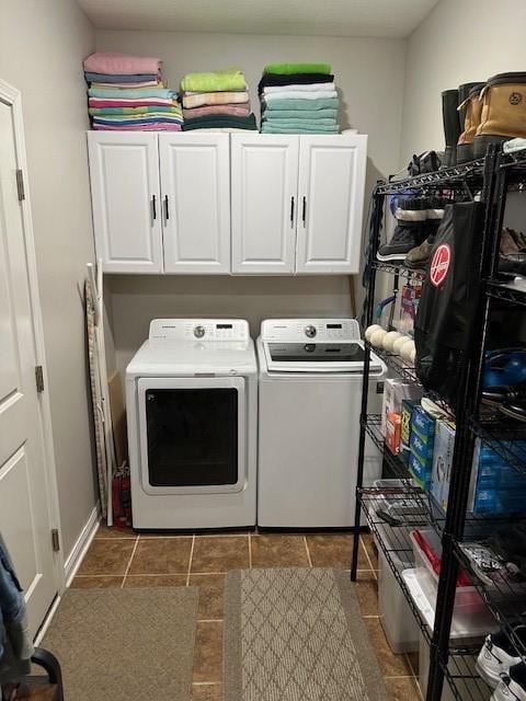 4017 160th St, Urbandale, IA 50323 - laundry area featuring washing machine and dryer, cabinet space, and dark tile patterned flooring