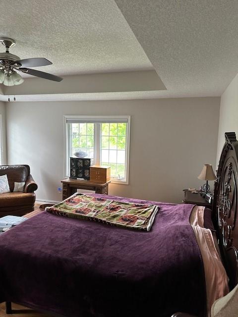 4017 160th St, Urbandale, IA 50323 - bedroom with a textured ceiling and a ceiling fan